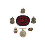 A WWII Defence medal, ARP cloth badge and three silver examples,