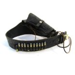 A US western style embossed black leather holster belt with dummy bullets