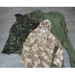 A box of miscellaneous post-war uniform including overalls together with two camo backpacks