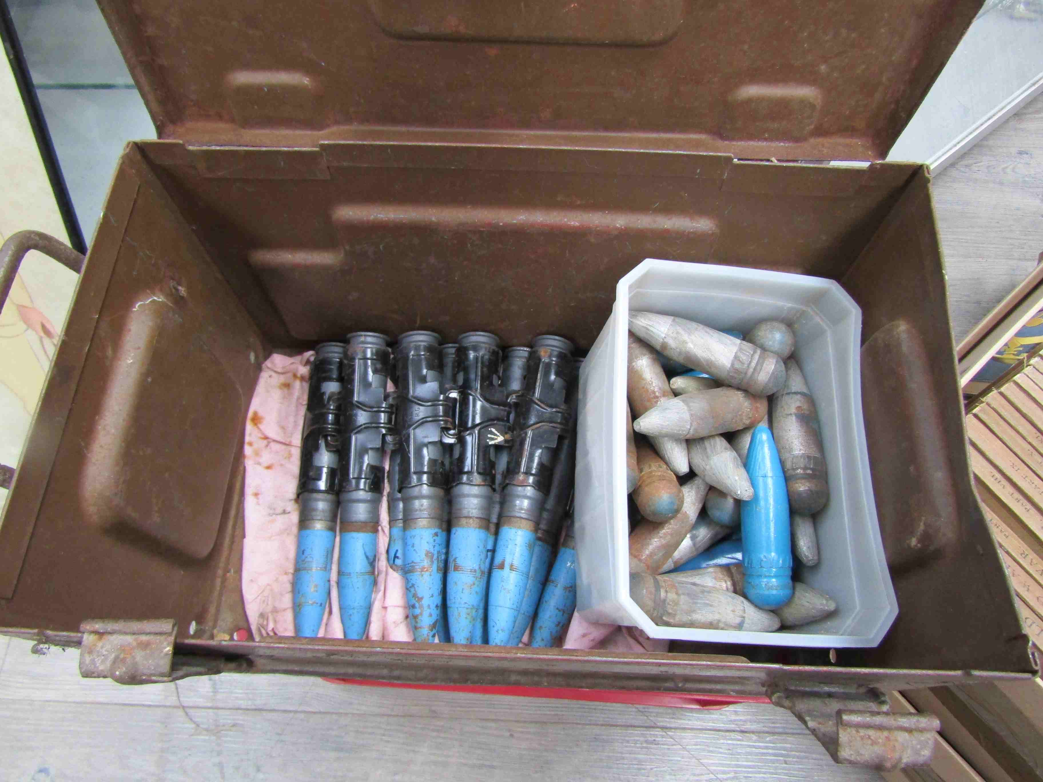 A 1955 dated ammunition case and a box containing various deactivated / inert rounds