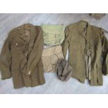 A box of militaria including ATS cap and tunics