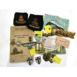 A collection of militaria including badges, buttons,