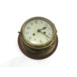A brass ship's clock, Arabic dial,