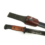 A WWII German K98 bayonet with wooden grips and scabbard