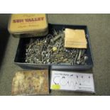 Three workshop drawer cabinets and various clock parts and consumables including clicks,
