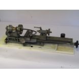 A centre lathe with index arm, four jaw chuck, hollow tailstock and swarf tray,