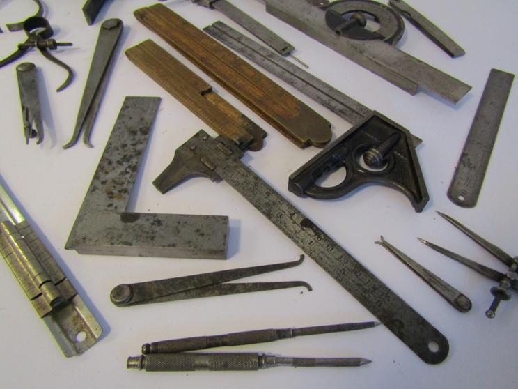 A box of measuring and marking tools including wooden and steel rukes, scribers, squares, calipers, - Image 2 of 4