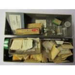 Five metal drawers of various watch parts and spares, mixed calibres, mainly stems, hands, crowns,