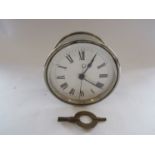 A nickel plated bulkhead style clock, case marked ERVII, with key,