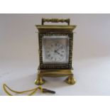 A small brass desk clock with an early 19th Century verge/fusee watch movement, signed Robert Hull,