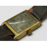 An early 20th Century gent's wristwatch in rolled gold case of rectangular form,