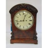 A Victorian flame mahogany bracket clock with silvered Roman dial,