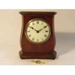 An Edwardian mahogany and strung inlaid timepiece of waisted form, enamelled Roman dial,