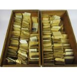 Two drawers containing a large quantity of watch balance staffs, stems,