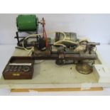 An 8mm watchmaker's lathe project, mounted on board, with flip-over T-rest, two motors, drawbar,