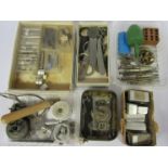 A box of mixed tools including movement holders, screwdrivers, spanners, balance stake, dust blower,