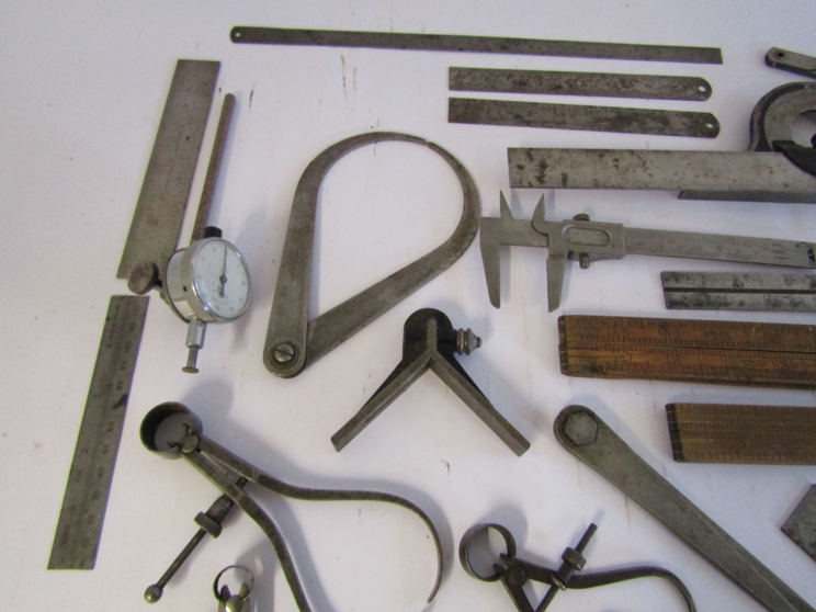 A box of measuring and marking tools including wooden and steel rukes, scribers, squares, calipers, - Image 3 of 4