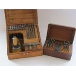 A cased staking set with assorted punches, stakes and mills (table damaged),