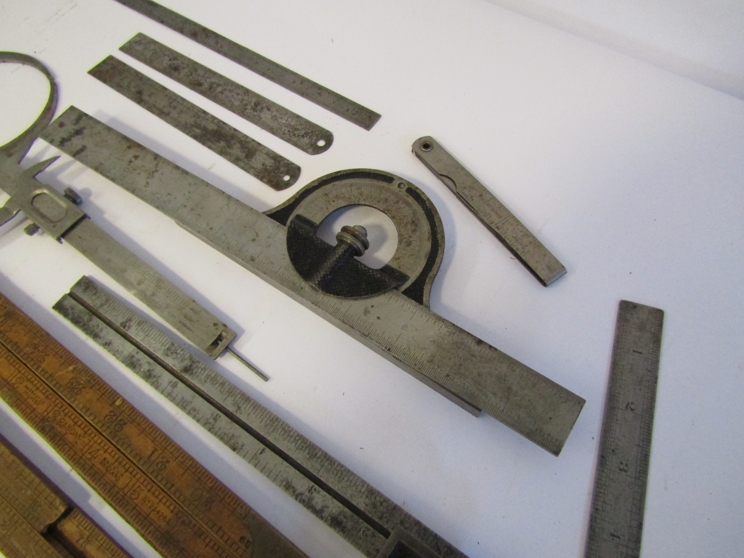 A box of measuring and marking tools including wooden and steel rukes, scribers, squares, calipers, - Image 4 of 4