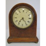 A mahogany arched form desk timepiece,