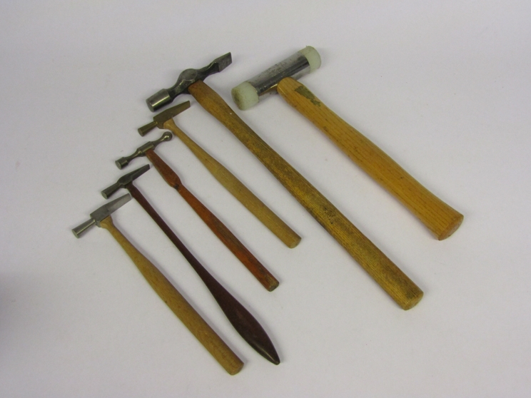 Four watchmaker's hammers including brass headed and ball pein,