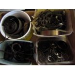 A box containing a large quantity of clock mainsprings, some unused,