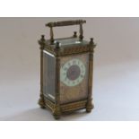 A late 19th Century French brass carriage timepiece with architectural design column and pierced