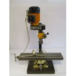 An Emco bench top milling machine with machine vice, milling table on X-Y cross slide,