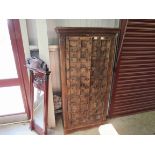 An Eastern hardwood studded full height cupboard