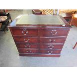 A mahogany 4 drawer filing unit with green leather top