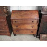 A 19th Century mahogany bureau with fitted interior over three drawers