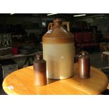 A large stoneware bottle and three smaller ones