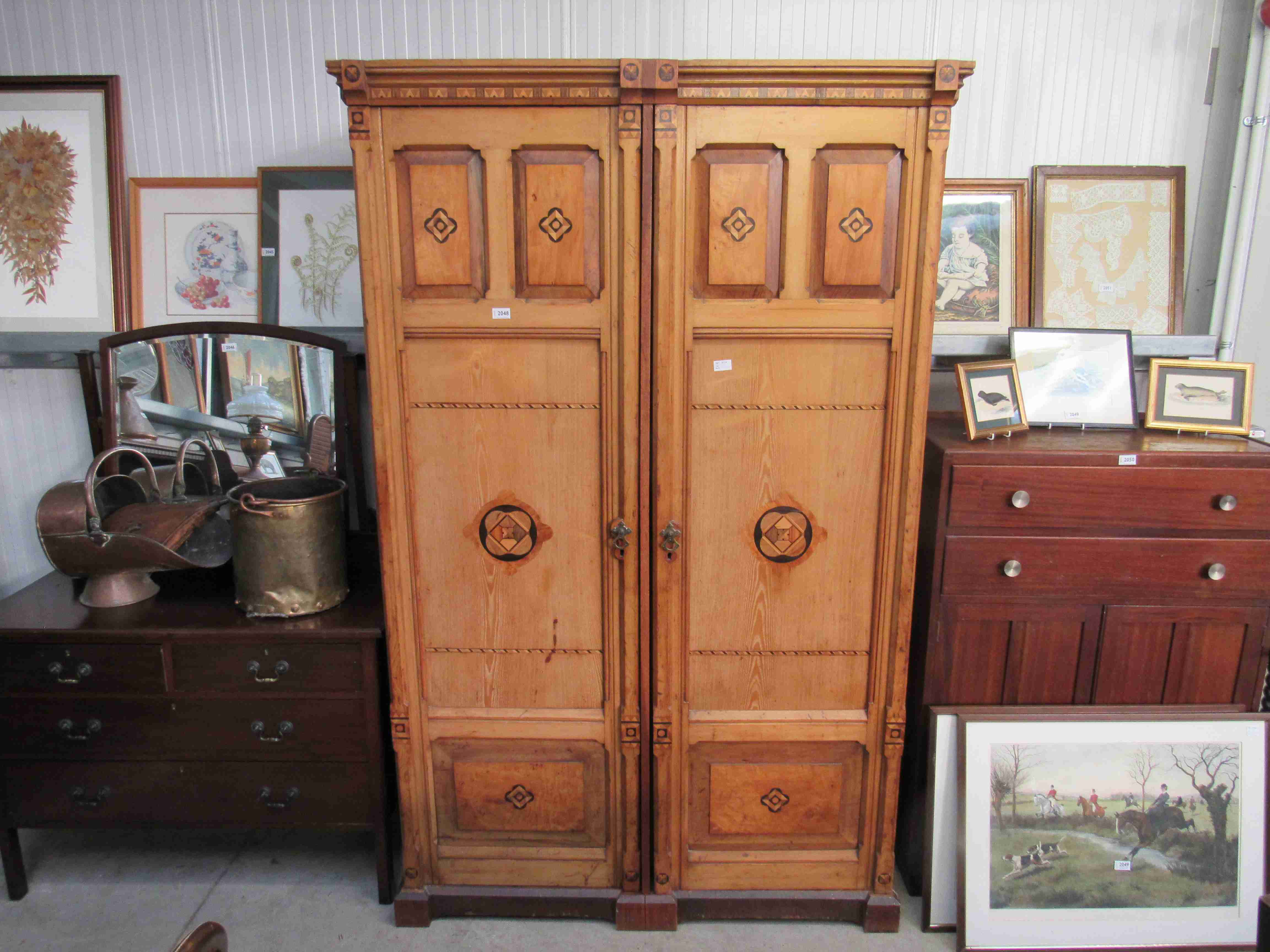 An Aesthetic period ash two door wardrobe unit with coloured parquetry decoration,