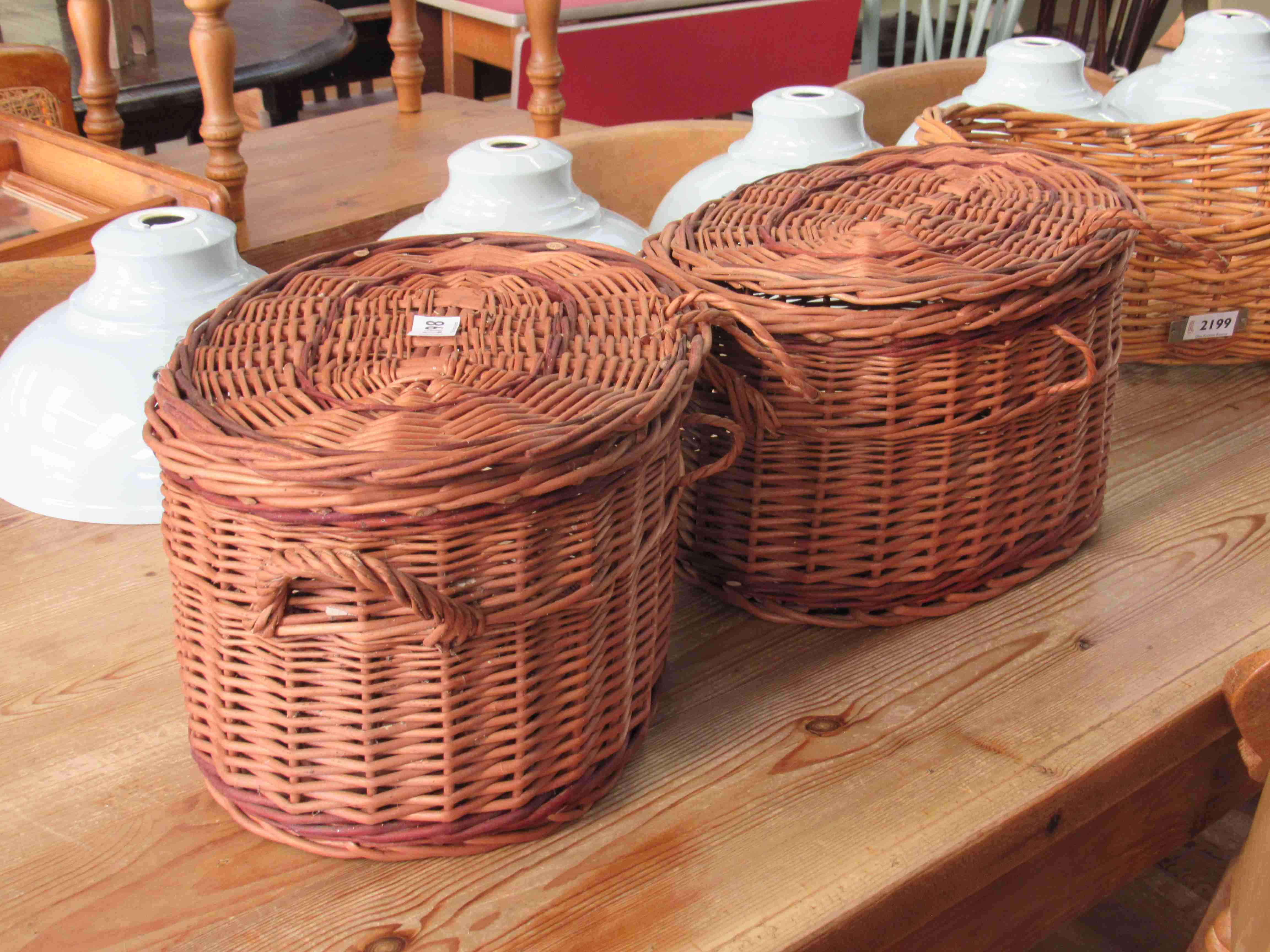 A pair of lidded wicker fishing baskets