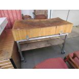 A butchers block on steel stand