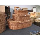 A set of three graduating wicker lidded baskets