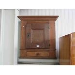 A 19th Century Continental oak wall cabinet with drawer