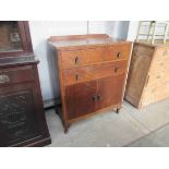 A 1940's oak tall boy cupboard,