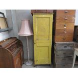 A 19th Century yellow painted pine single door cupboard