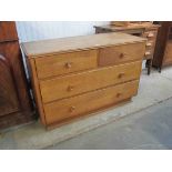 A 1950's oak two over two chest of drawers