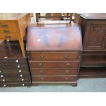 A reproduction Georgian style mahogany bureau with four drawers