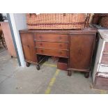 A 1930's Gothic carved oak three drawer, two door sideboard ,