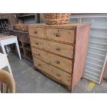 A Victorian waxed pine and mahogany two over three chest of drawers with mahogany handles