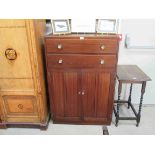 A 1940's utility mahogany tall boy with two drawers over two cupboard doors