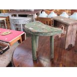 A Victorian green painted elm milking stool