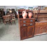 A small Edwardian walnut housekeepers cupboard with shelved back over two drawer,