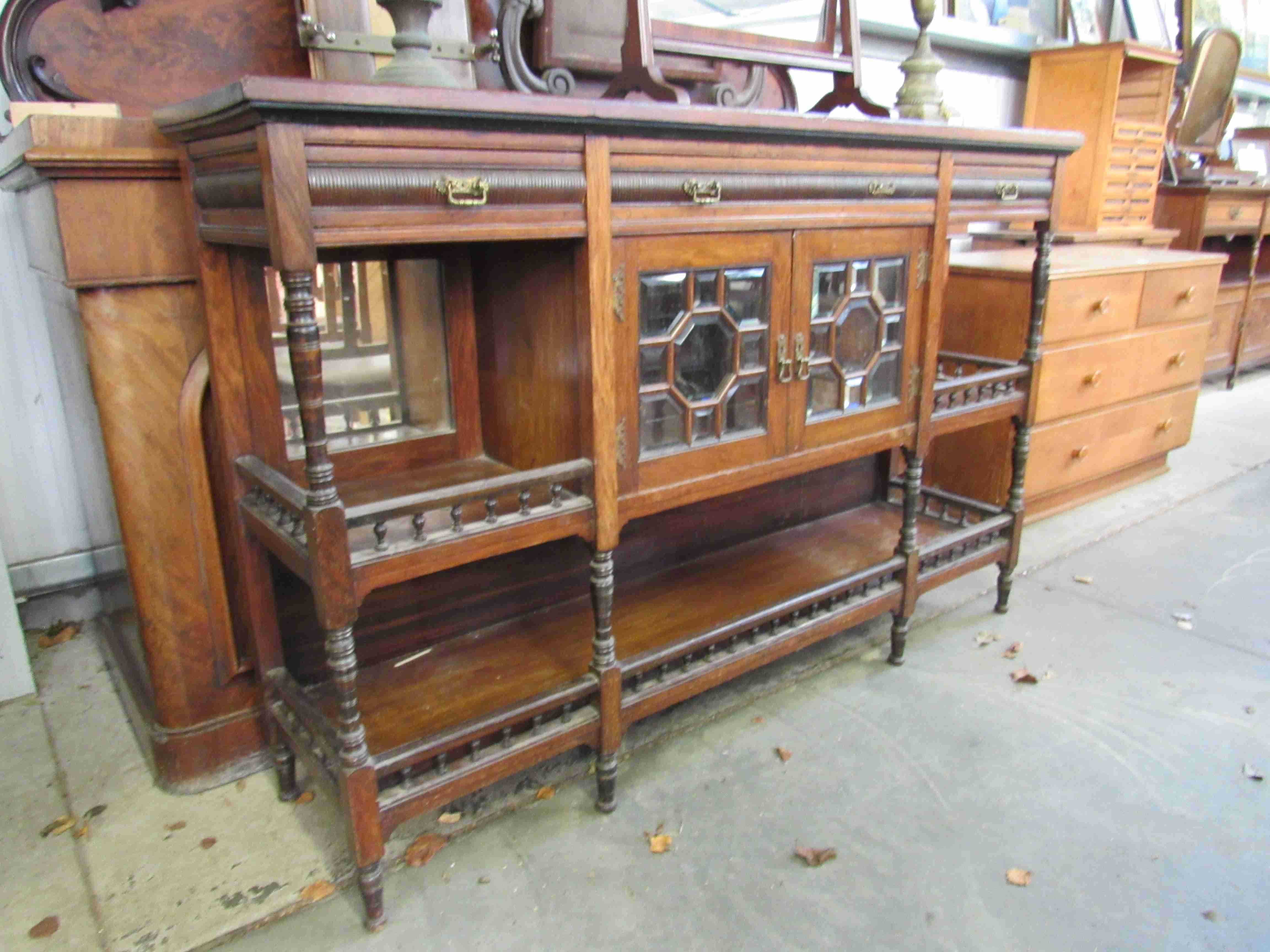 A Jas Shoolbred & Co 19th Century rosewood sideboard with two bevelled glass doors and spindle rail