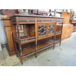 A Jas Shoolbred & Co 19th Century rosewood sideboard with two bevelled glass doors and spindle rail