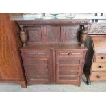 A mid 20th Century carved oak court cupboard in one piece,