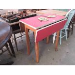 A 1960's Formica top drop-leaf kitchen table